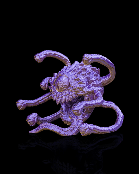 Metallic creature figurine on a black background