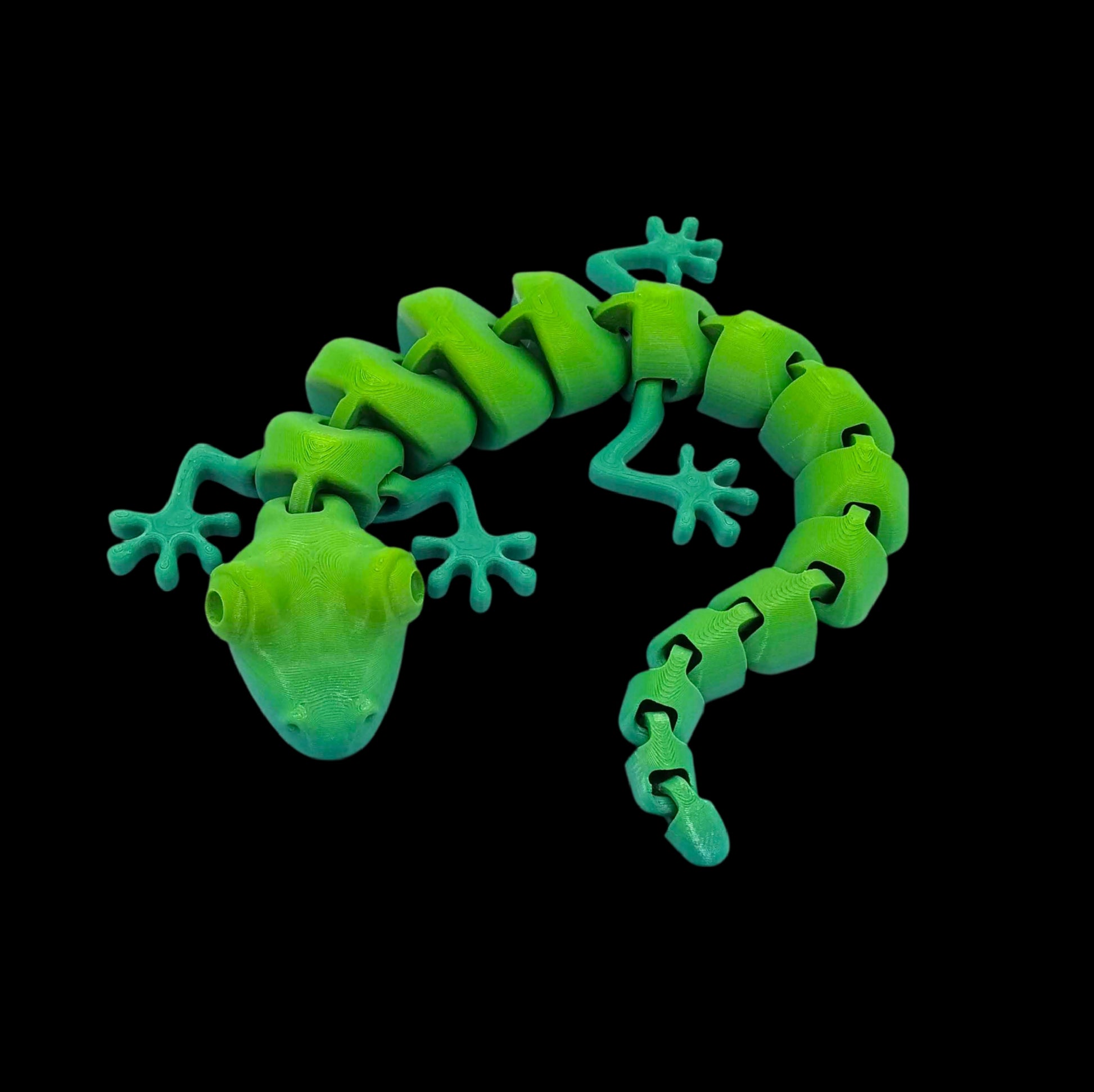 Glowing green lizard toy on a black background
