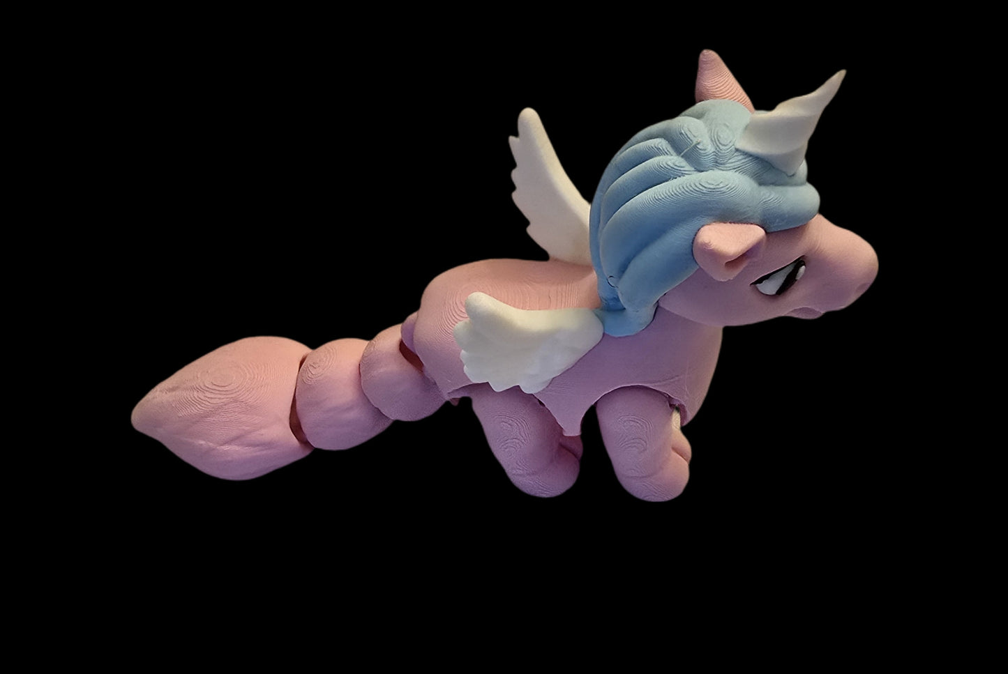 Pink and blue creature with wings on a black background