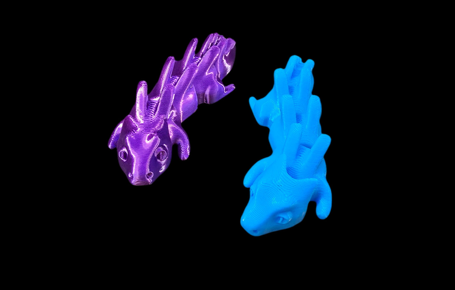 Purple and blue 3D-printed models on a black background