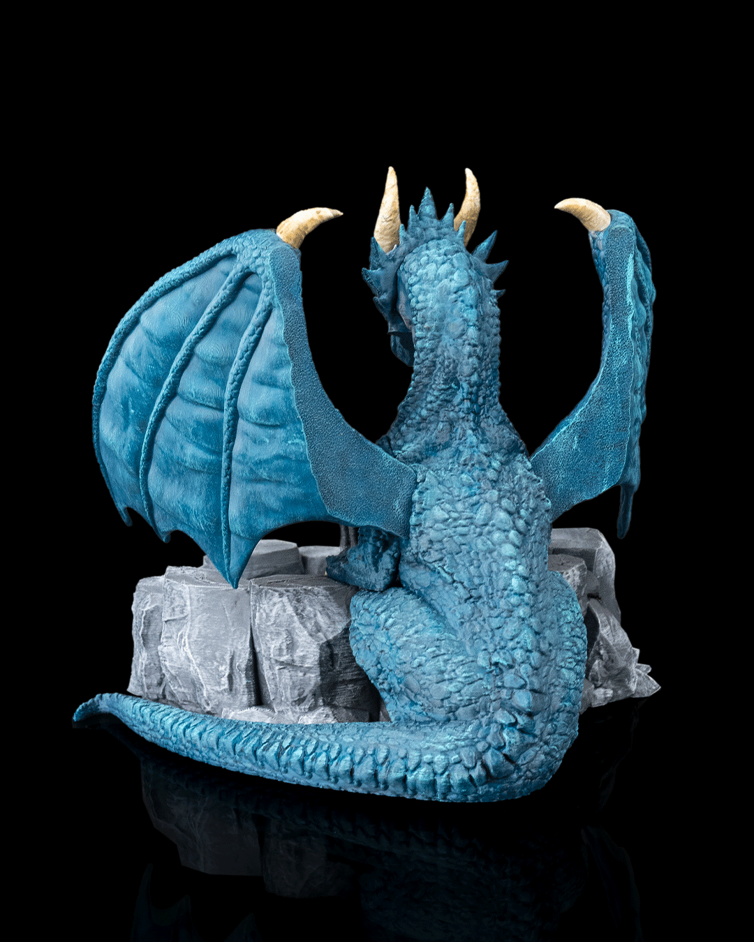 Blue dragon figurine on a black background