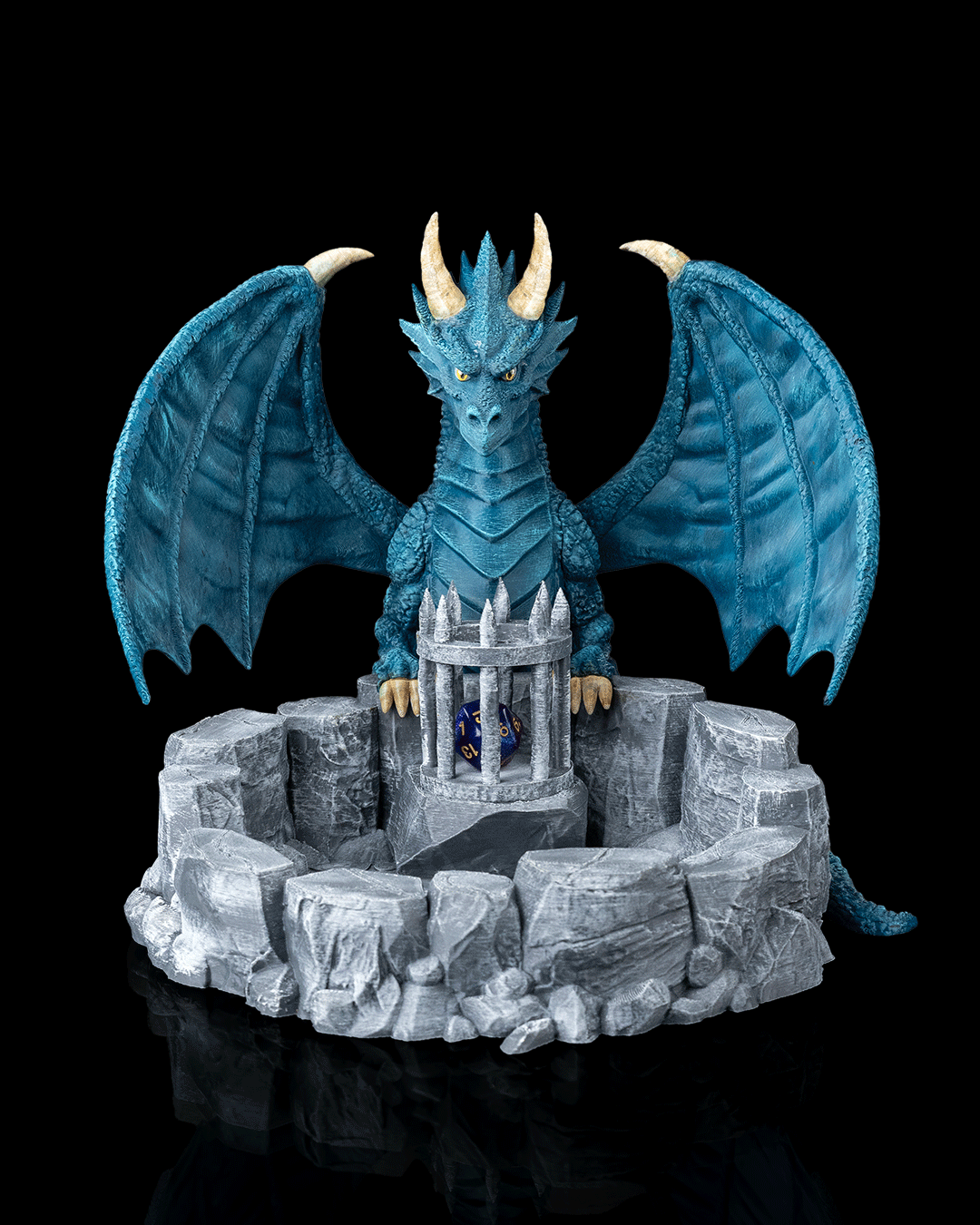 Blue dragon figurine with a castle on a rocky base against a black background