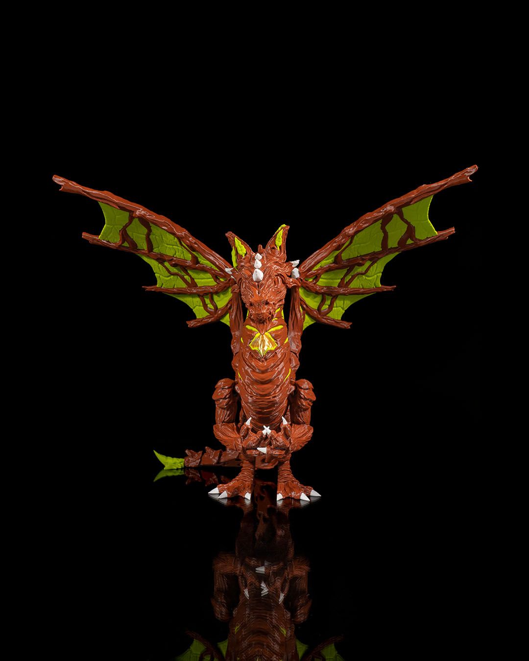 Moss dragon figure with green wings on a black background