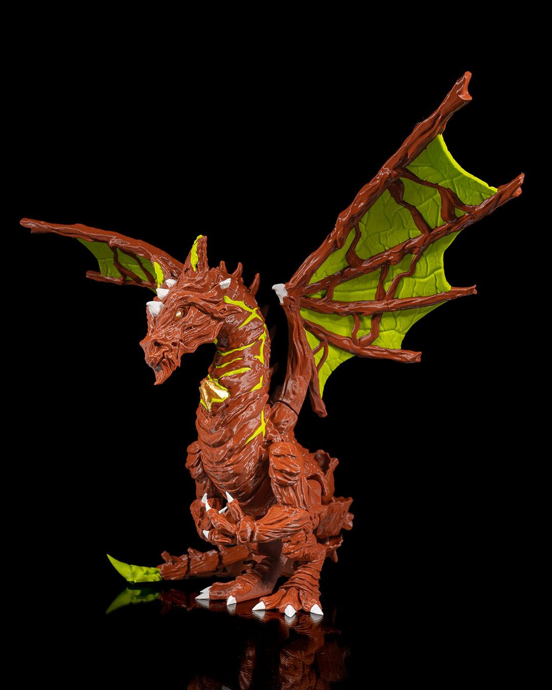 Moss Dragon figurine with green wings on a black background