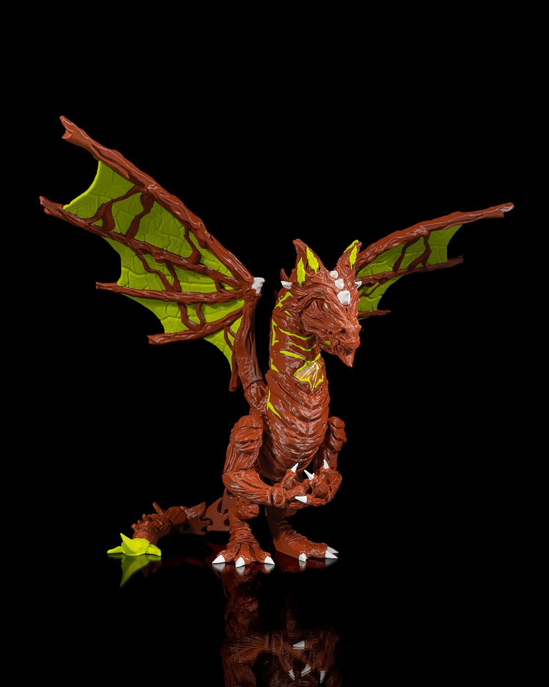 Moss Dragon-like creature figurine with green wings on a black background