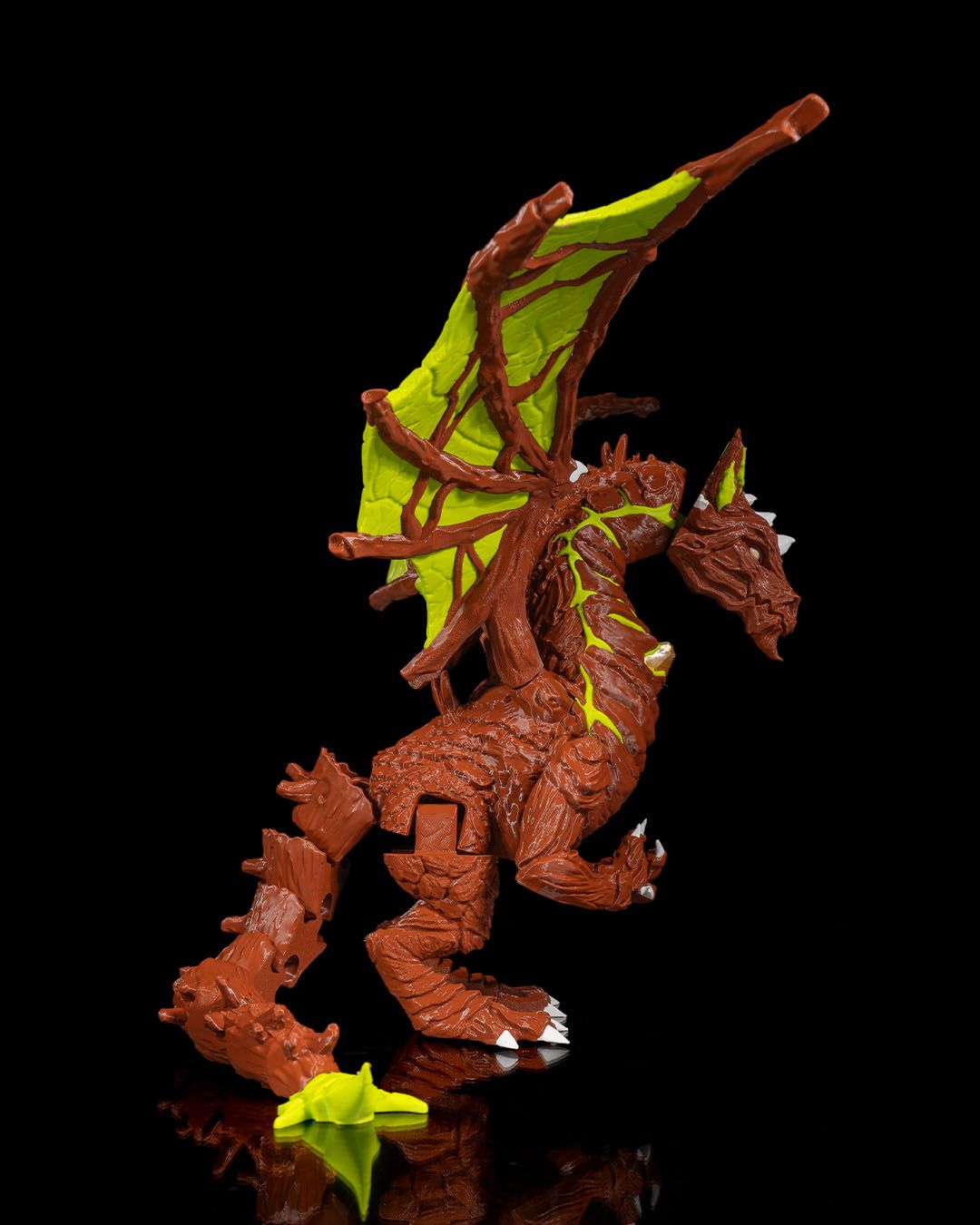 Moss Toy dragon figure with green wings on a black background
