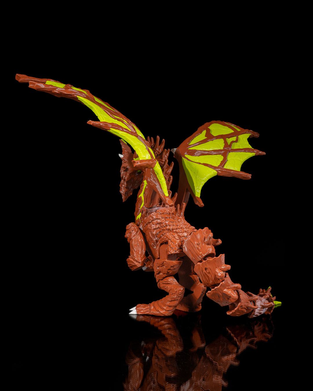 Moss Toy dragon figure with green wings on a  black background