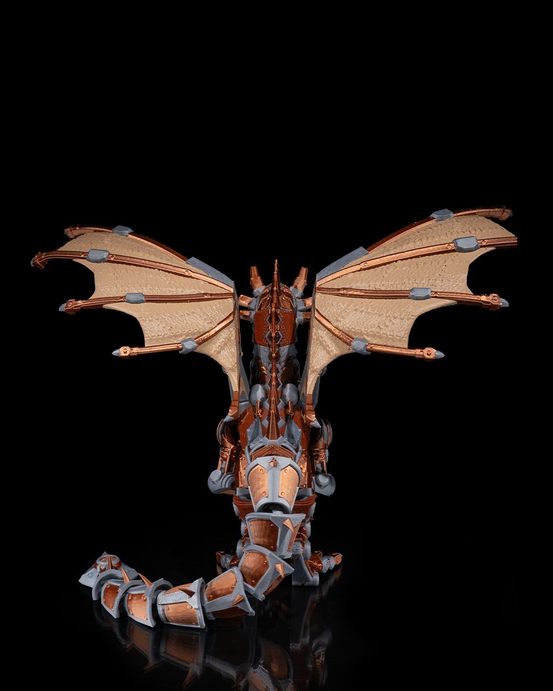 Dragon figurine with detailed wings and scales on a black background