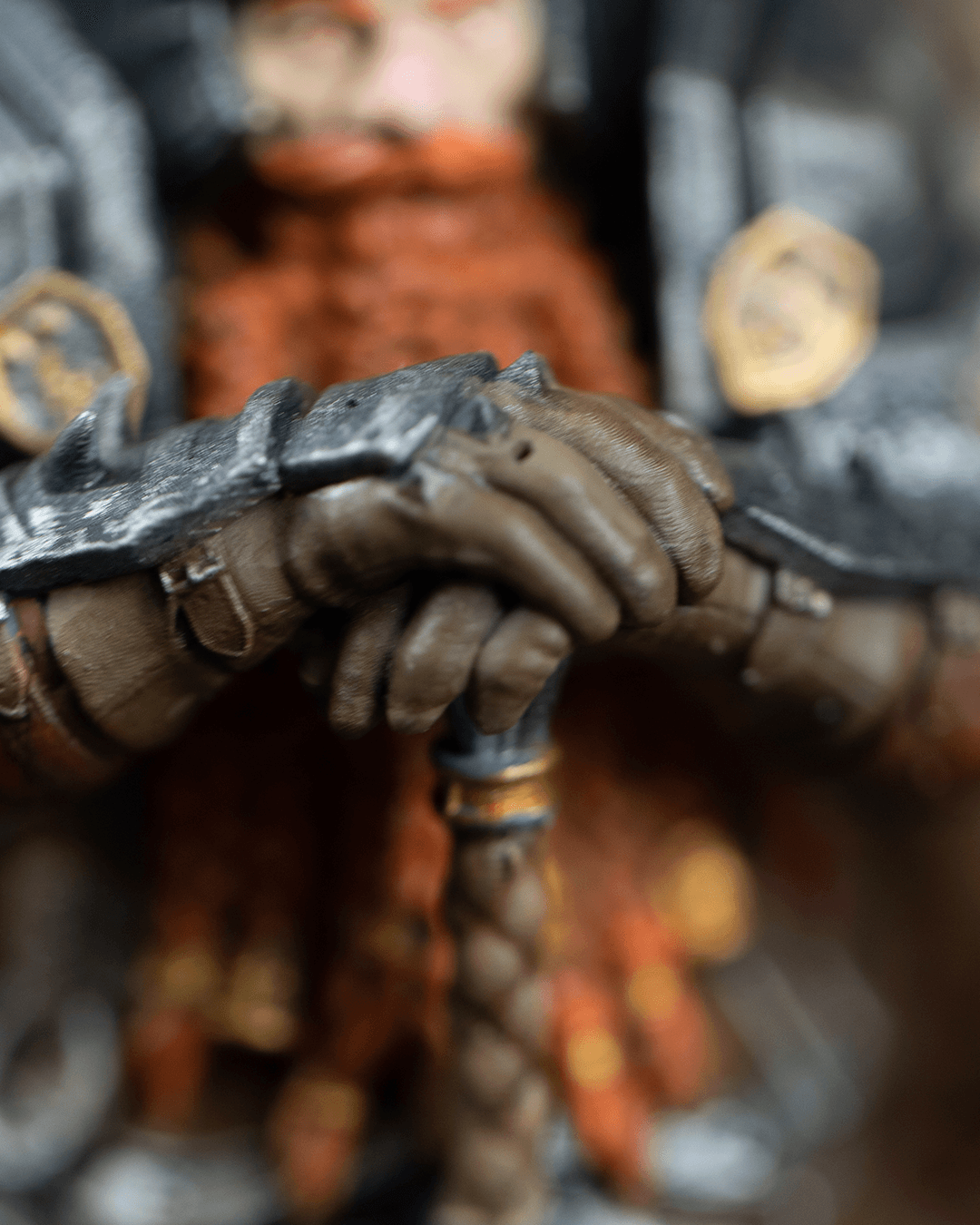 Close-up of a detailed figurine with armor and weapon, blurred background