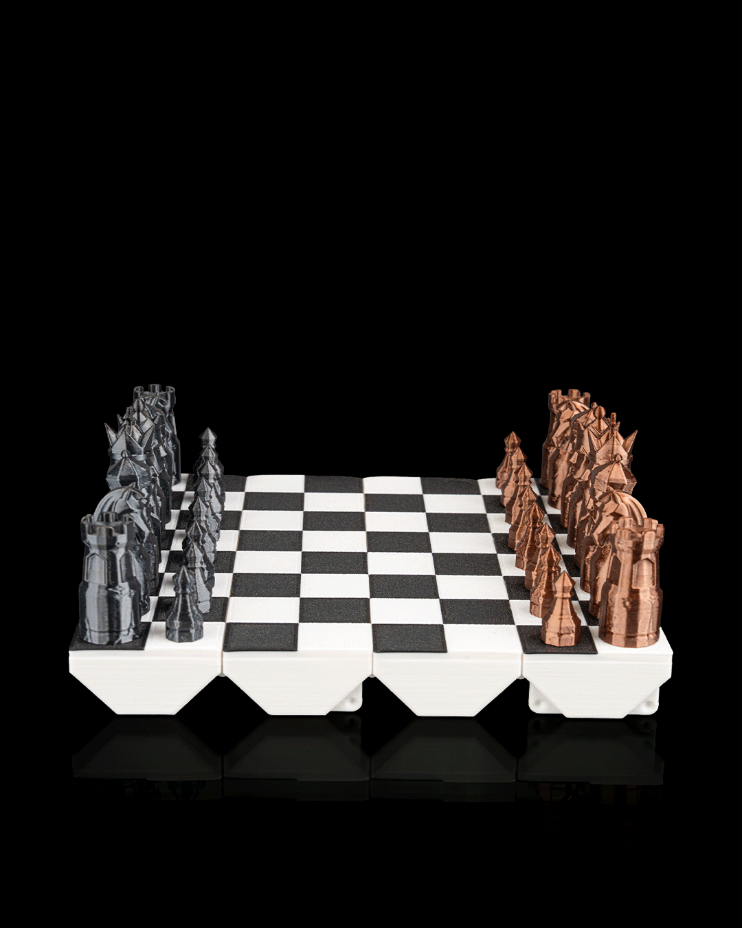 3D printed portable chess set, folded open for play with all pieces contained, classic black and white design, shown next to its closed, compact form.