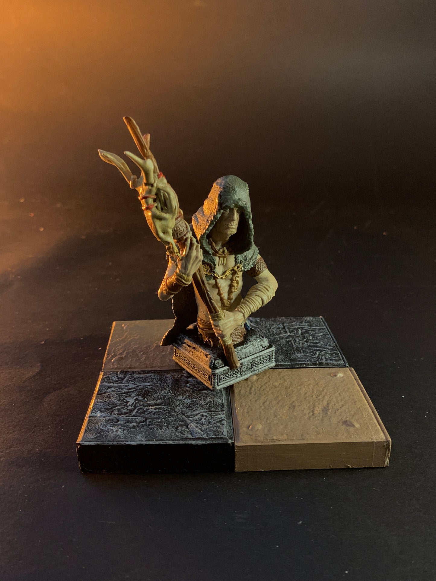 Bronze sculpture of a hand holding a book on a dark background chess pawn