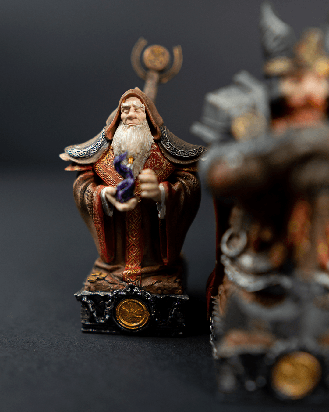 Statue of a wizard holding a staff on a dark background