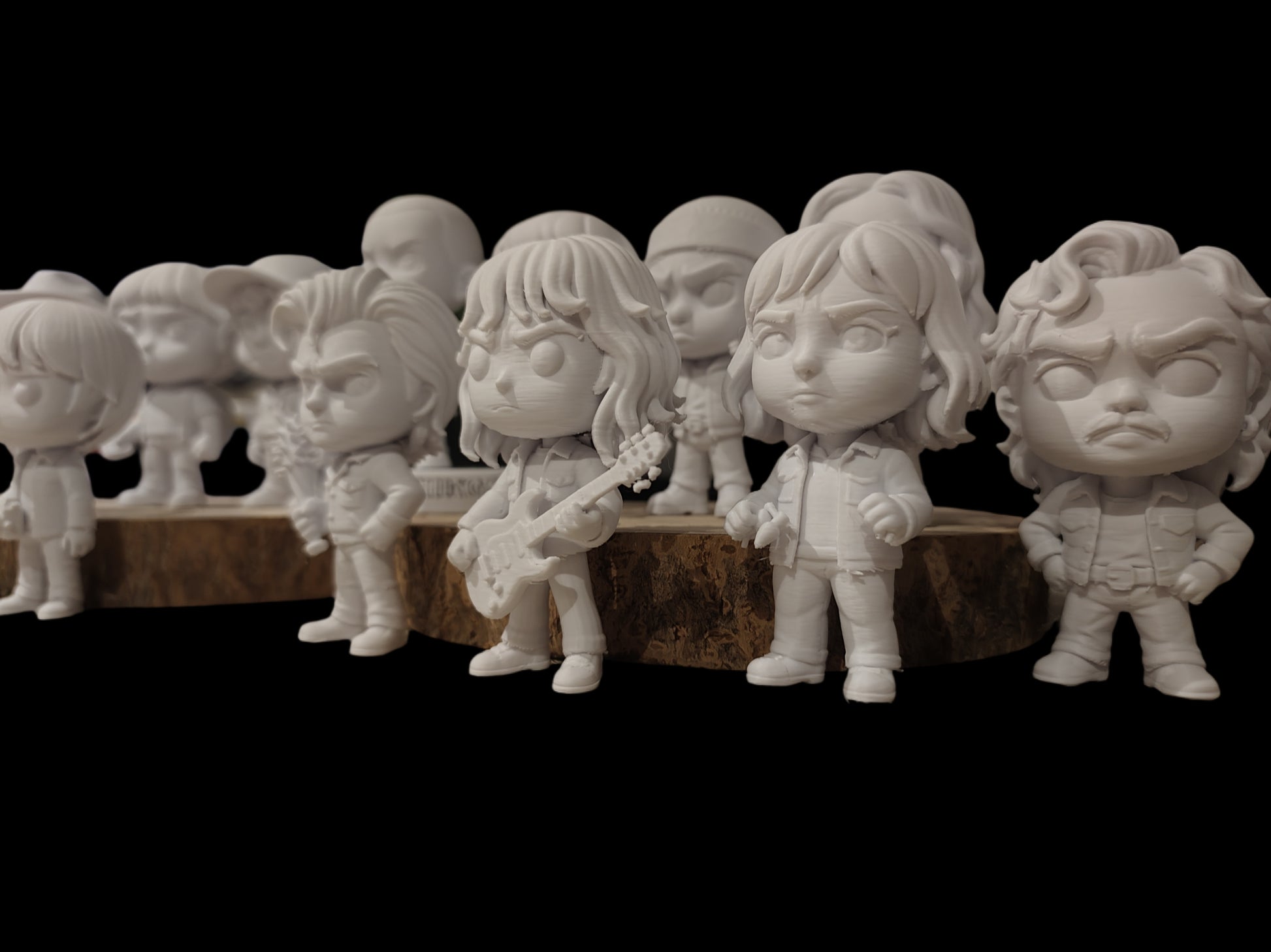 Row of white ceramic figurines on a dark background