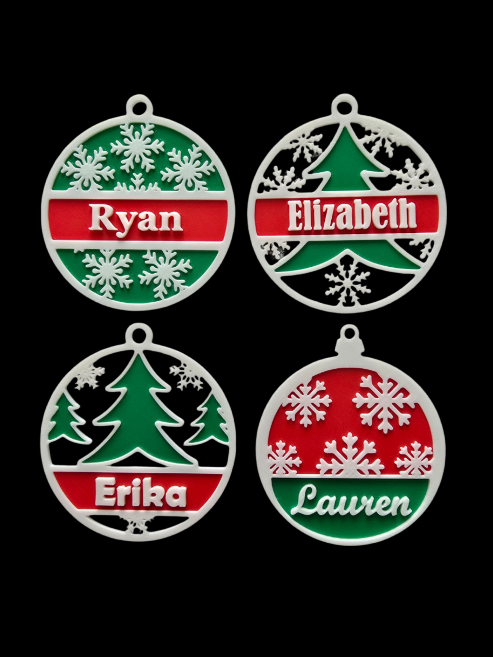Four Christmas ornaments with names 'Ryan', 'Elizabeth', 'Erika', and 'Lauren' on a black background.