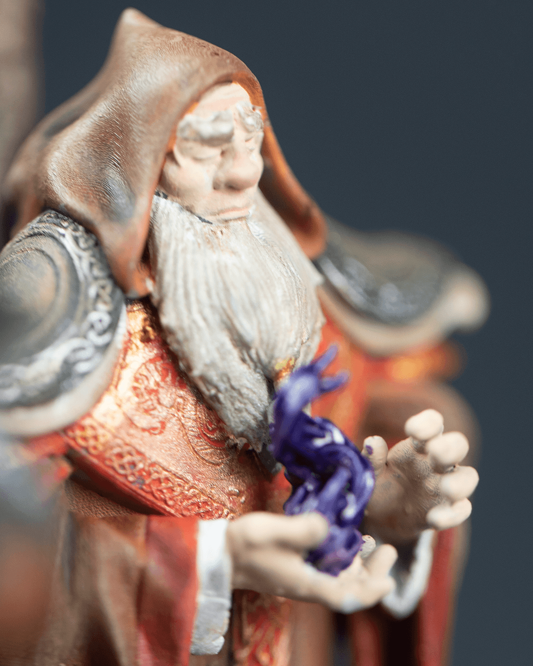Close-up of a figurine with intricate details and vibrant colors against a dark background