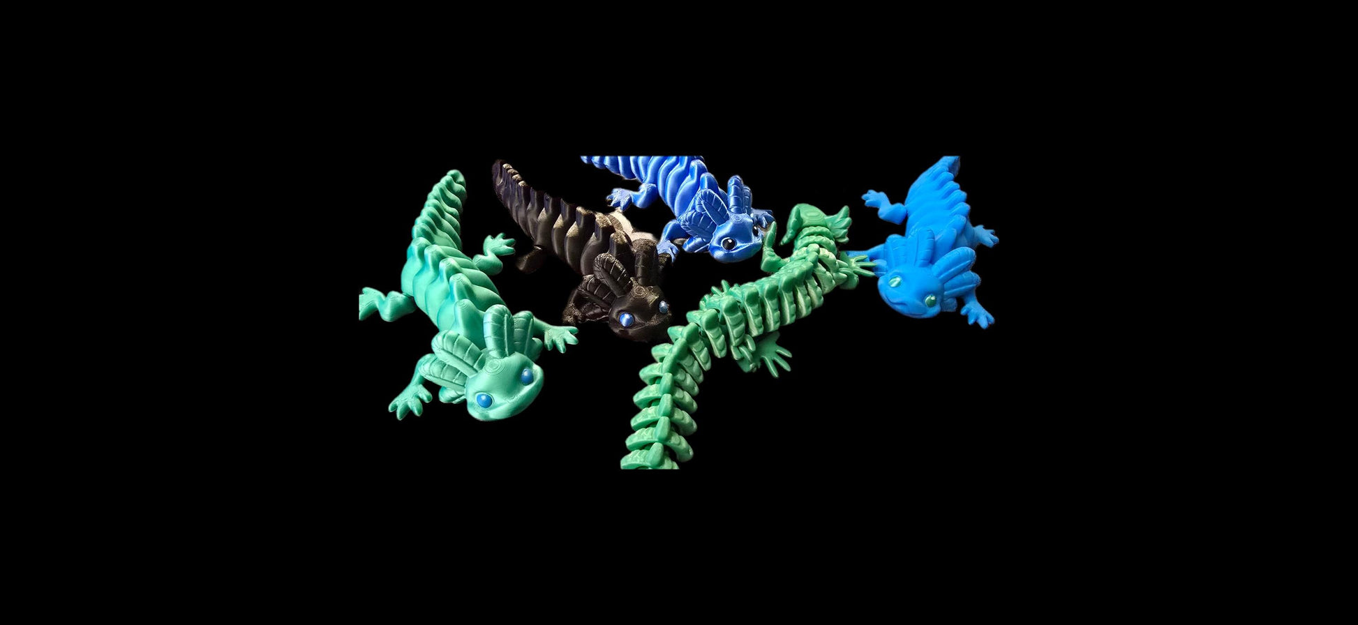 3D printed articulated axolotl v1 figurine in pastel pink PLA+, detailed gills and limbs, flexible body, proudly made locally in Ottawa, displayed on a light wooden surface.