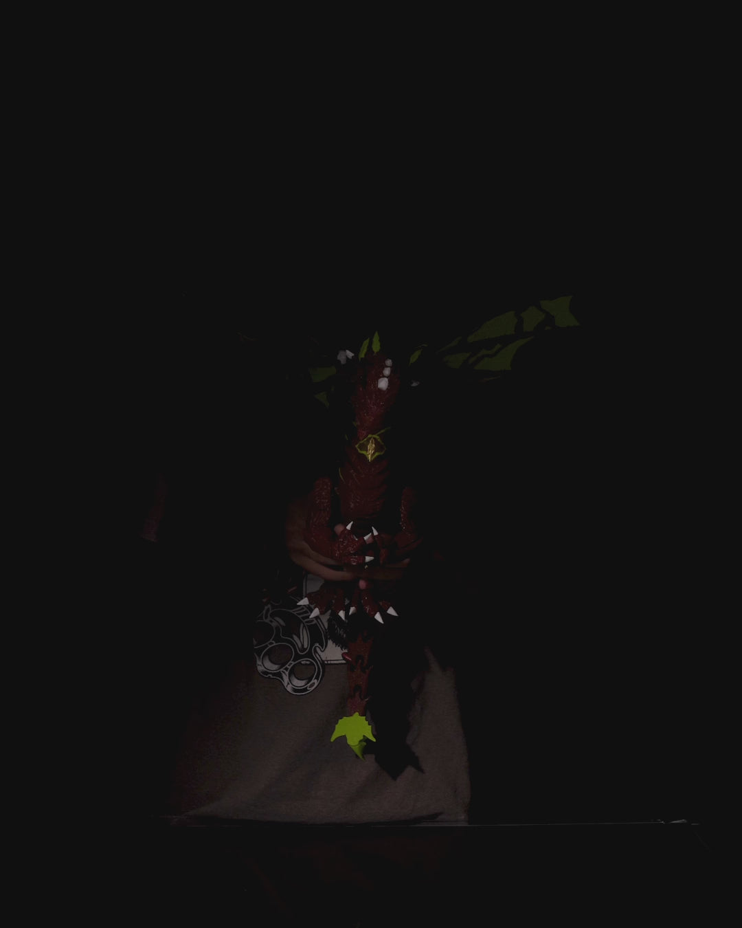 Moss Toy dragon figure with green wings on a  black background