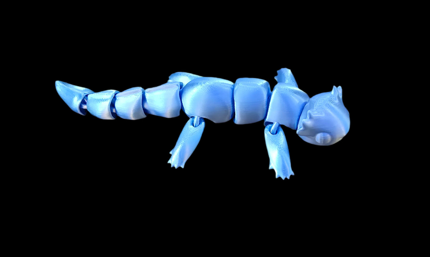 3D printed articulated v4 axolotl figurine in pastel pink PLA+, detailed gills and limbs, flexible body, proudly made locally in Ottawa, displayed on a light wooden surface.